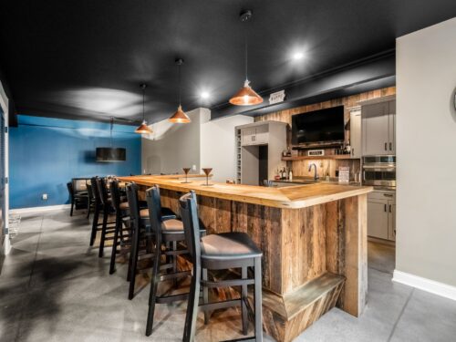 Basement remodel and full bar kitchen with reclaimed barnwood and copper pendants