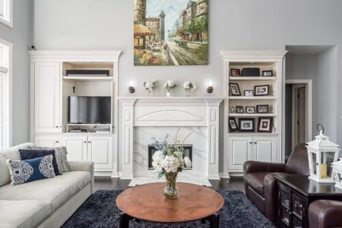 Home Remodel showing Picturesque built ins with simple quartz fireplace surround