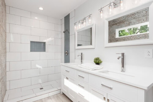 reflections of a tile wall in well lit bathroom