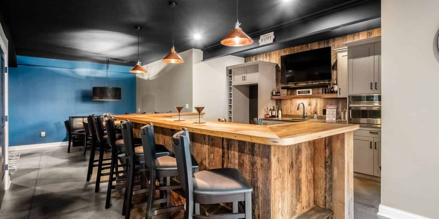 Basement remodel and full bar kitchen with reclaimed barnwood and copper pendants